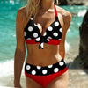 a woman in a polka dot bikini on the beach